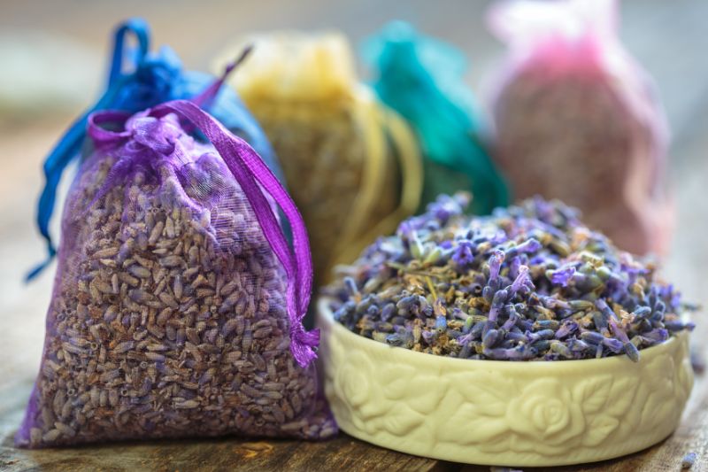 a scented sachet sat next to a bowl with contents of a filled sachet