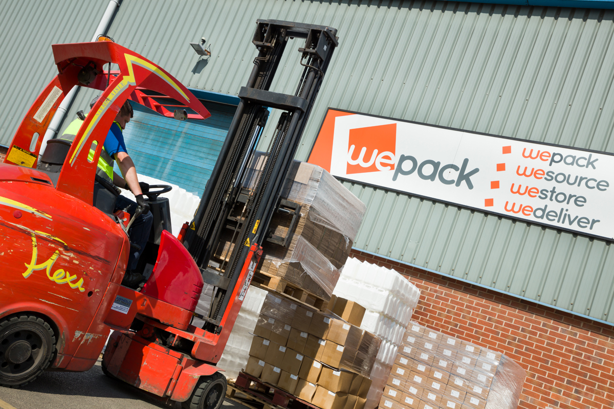 a forklift moving products outside of a contract packing company