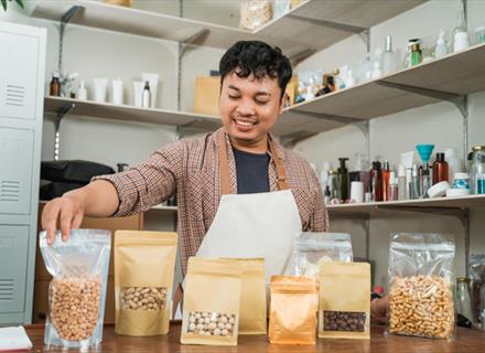 a man packing different food products into different packaging